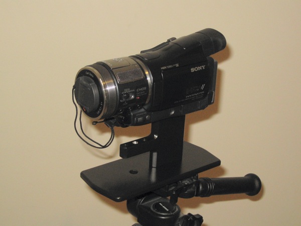 Camera and adapter mounted onto tripod